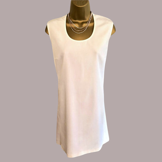 Mannequin wearing a cream mini dress on a beige background