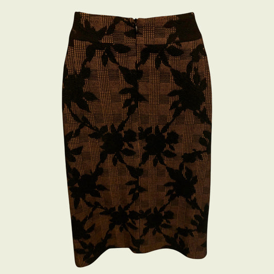 Brown skirt with black floral pattern on a beige background