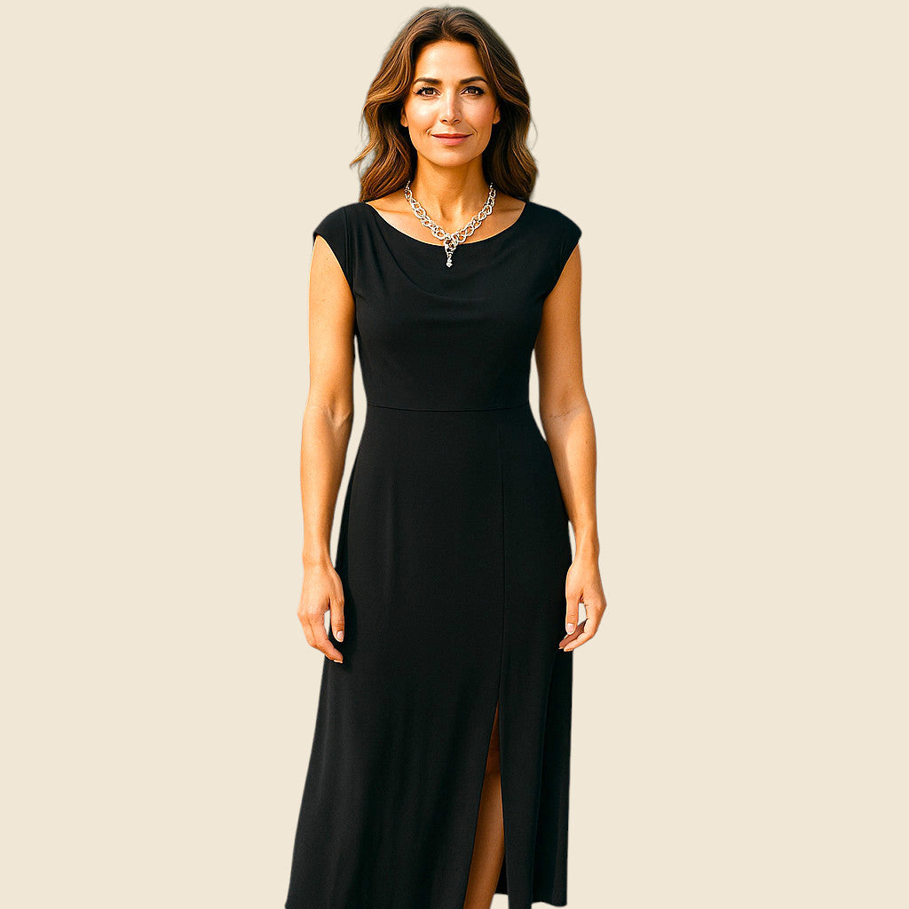 Woman wearing a black dress with a plain background