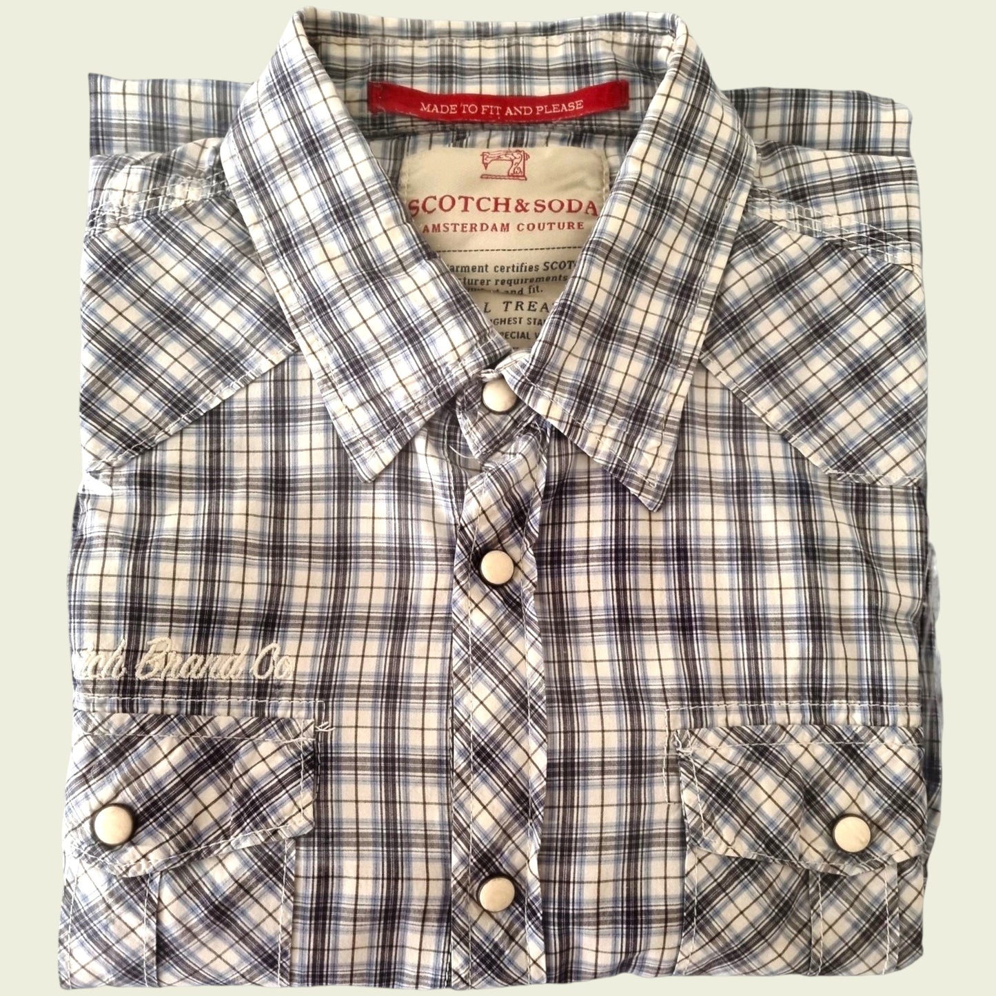 Plaid shirt with visible branding on a light background