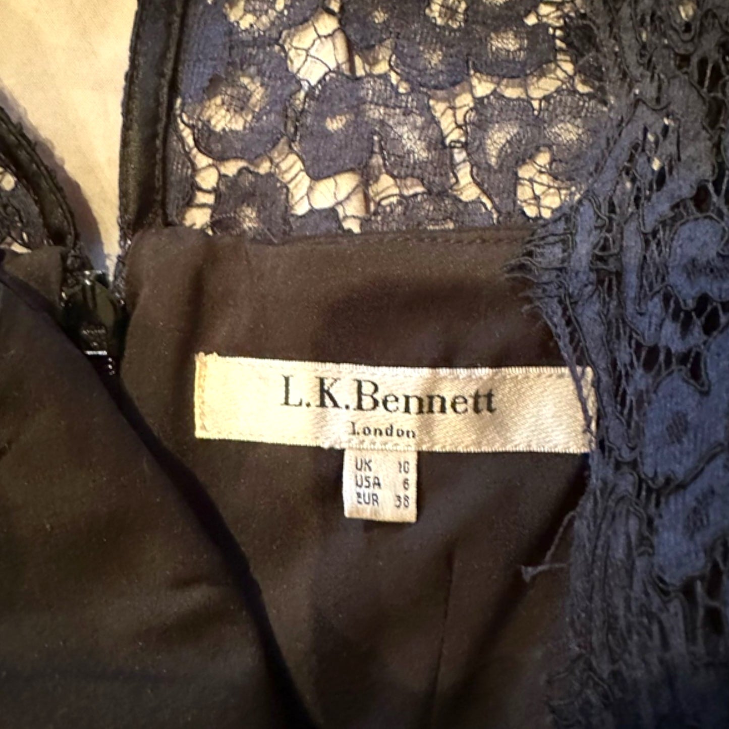 Dress label with L. K. Bennett London and size details on black background