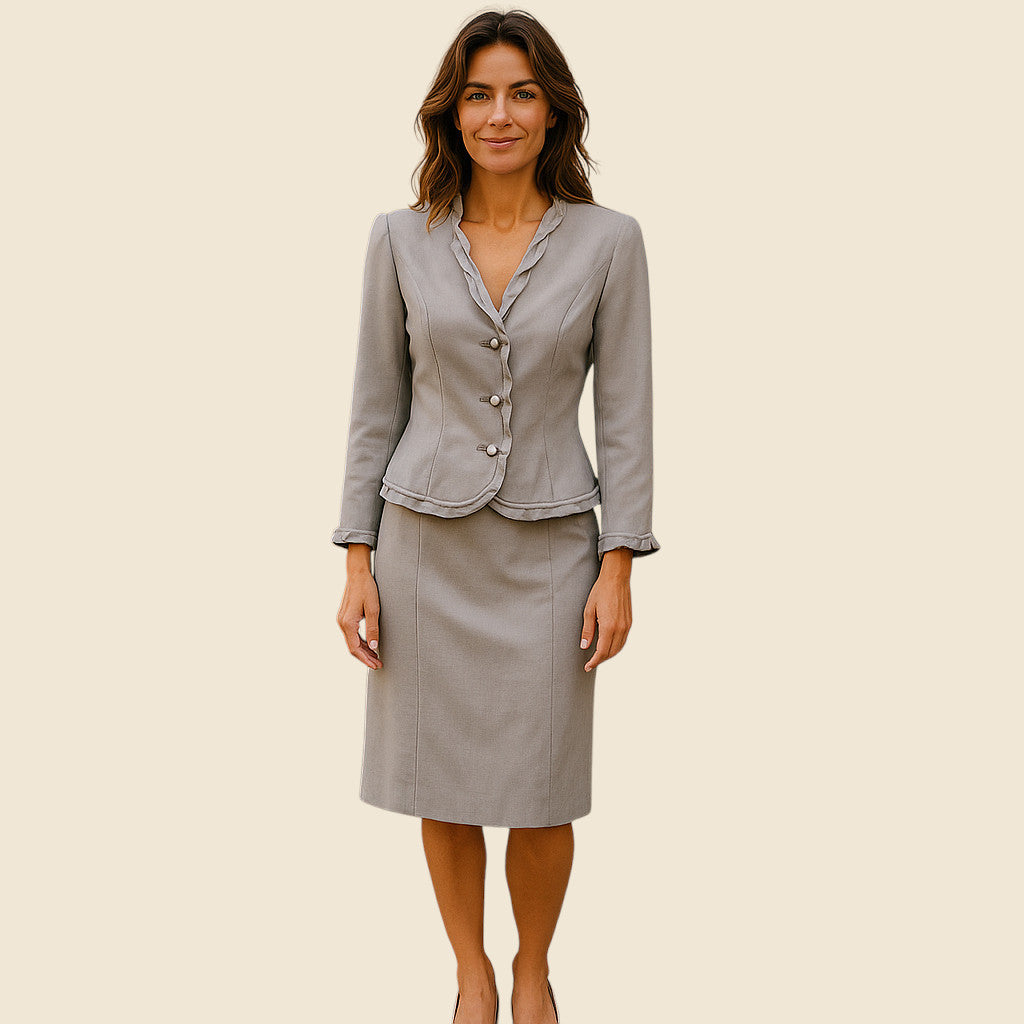 Woman wearing a gray suit on a beige background
