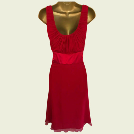 Red dress on a mannequin against a beige background