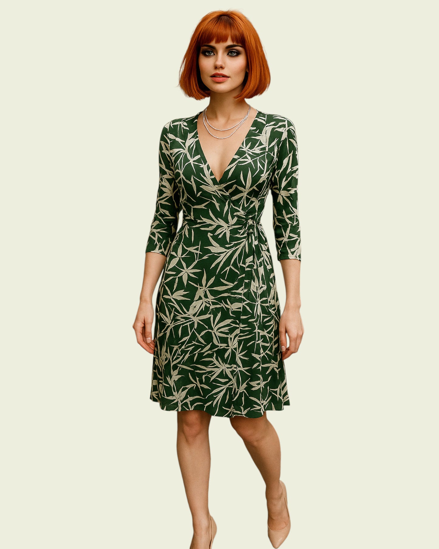 Woman wearing a green dress with leaf pattern on a beige background