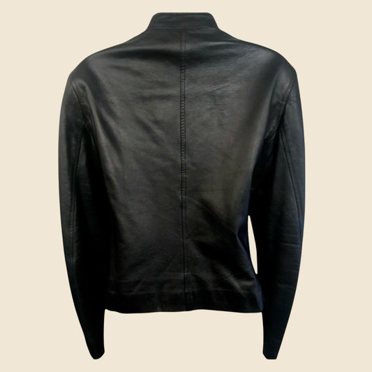 Black leather jacket on a beige background