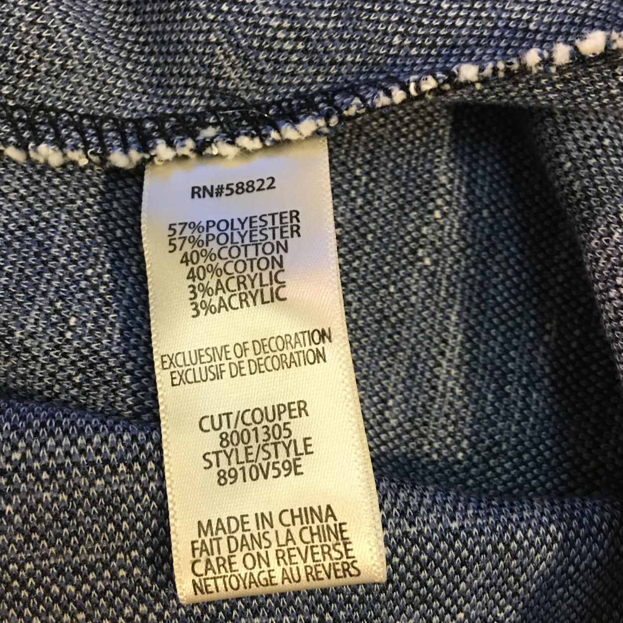 Fabric tag with material composition details on a denim background