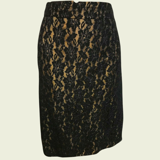 Black and gold patterned skirt on a beige background