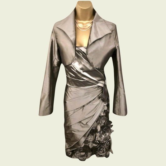 Metallic silver dress on a mannequin with a beige background