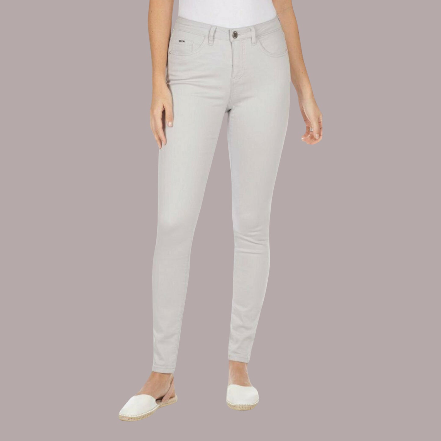 Light gray jeans worn by a person on a plain background