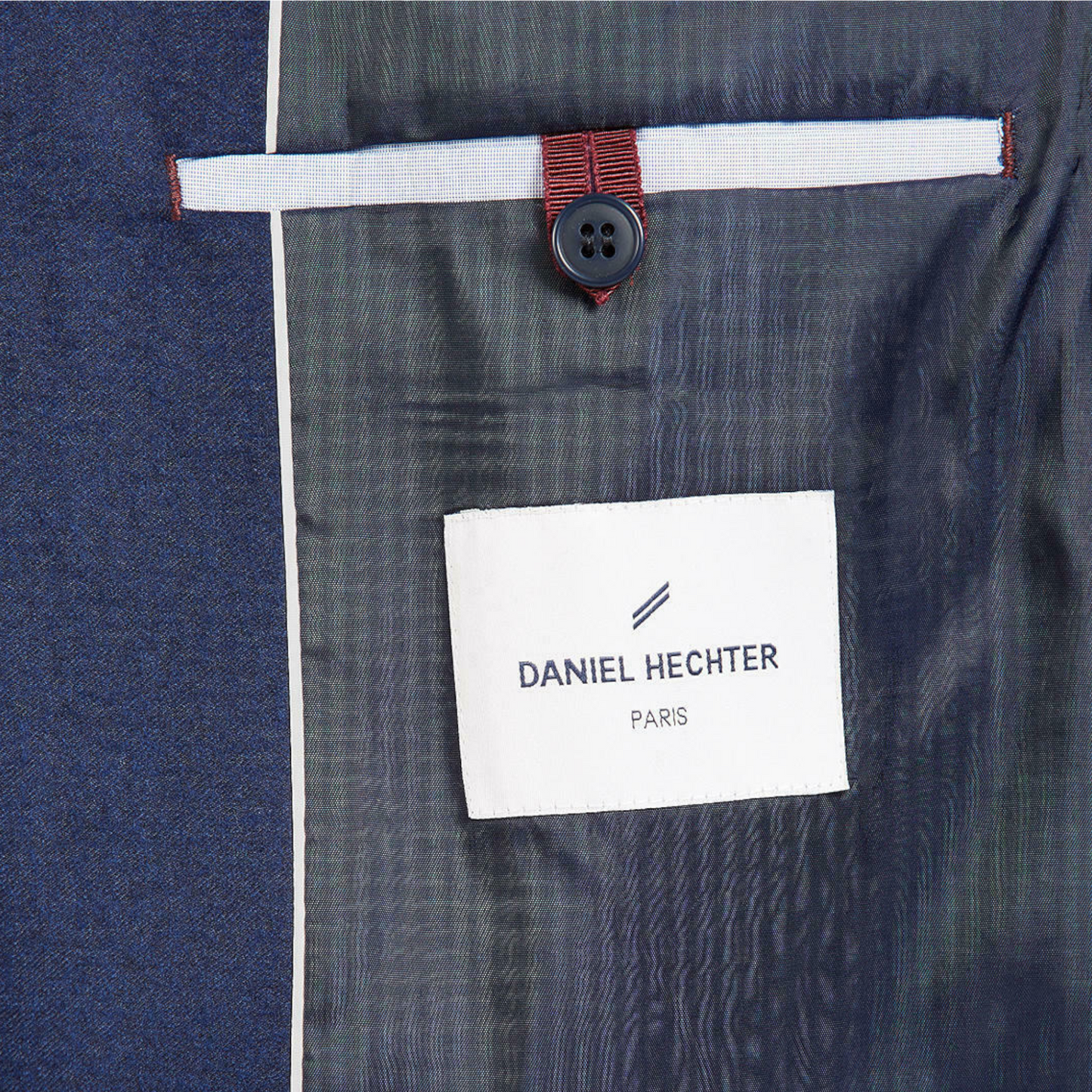 Close-up of a suit with a Daniel Hechter label on a blue background