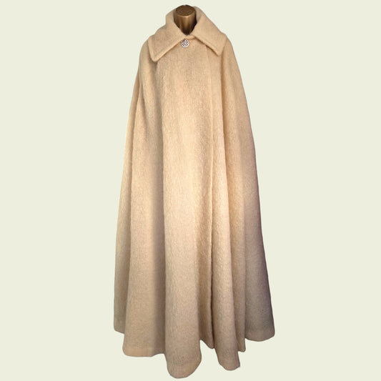 Beige cape on a mannequin against a beige background