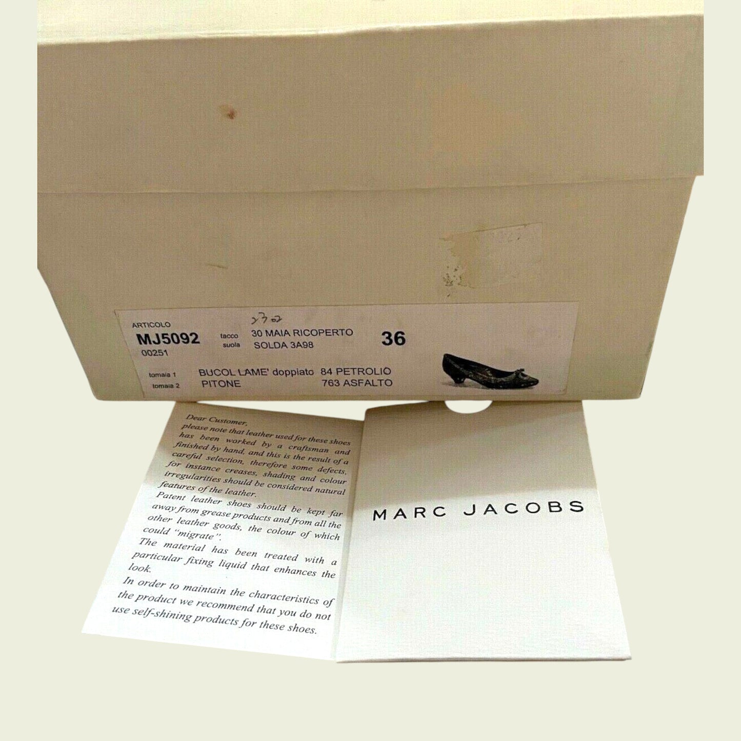 Marc Jacobs shoe box with a card inside on a light background