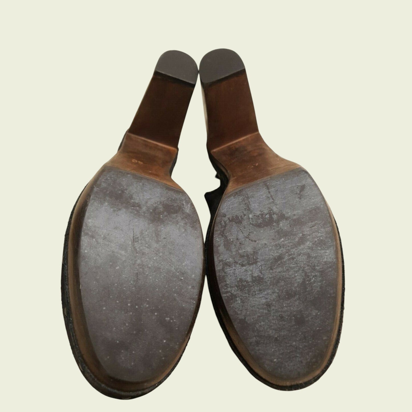 Pair of leather shoe soles on a beige background