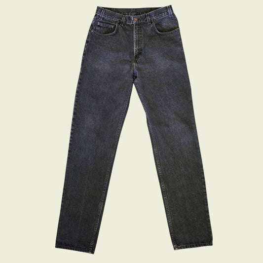 Pair of black jeans on a beige background