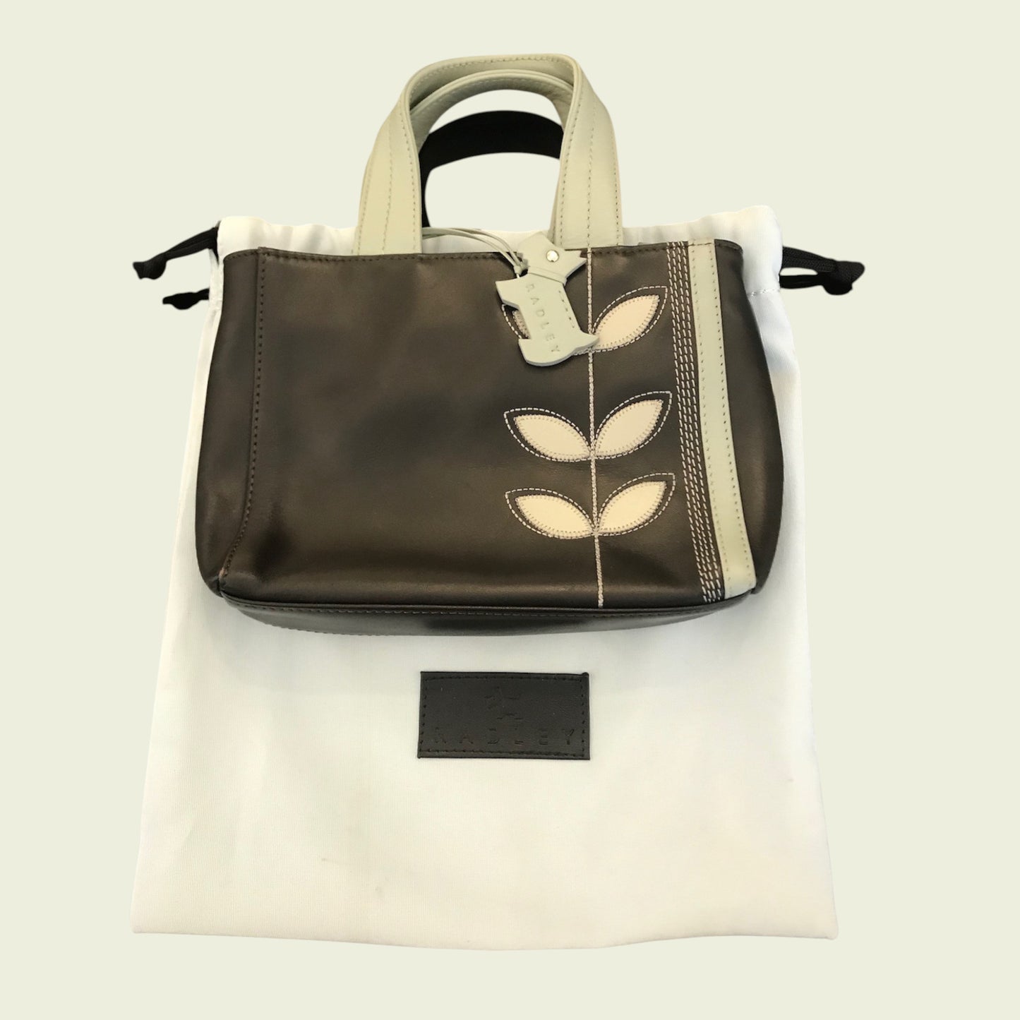 Handbag with leaf design on a white background