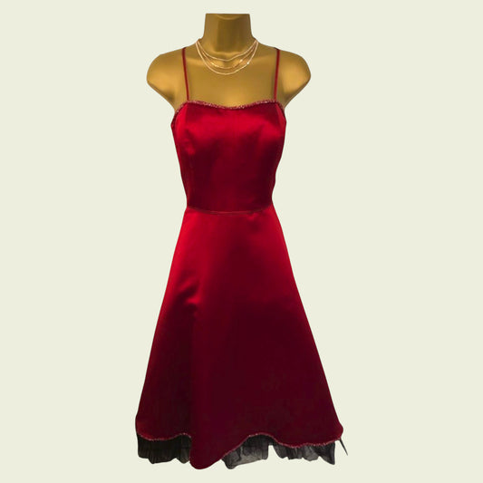 Red dress on mannequin on beige background