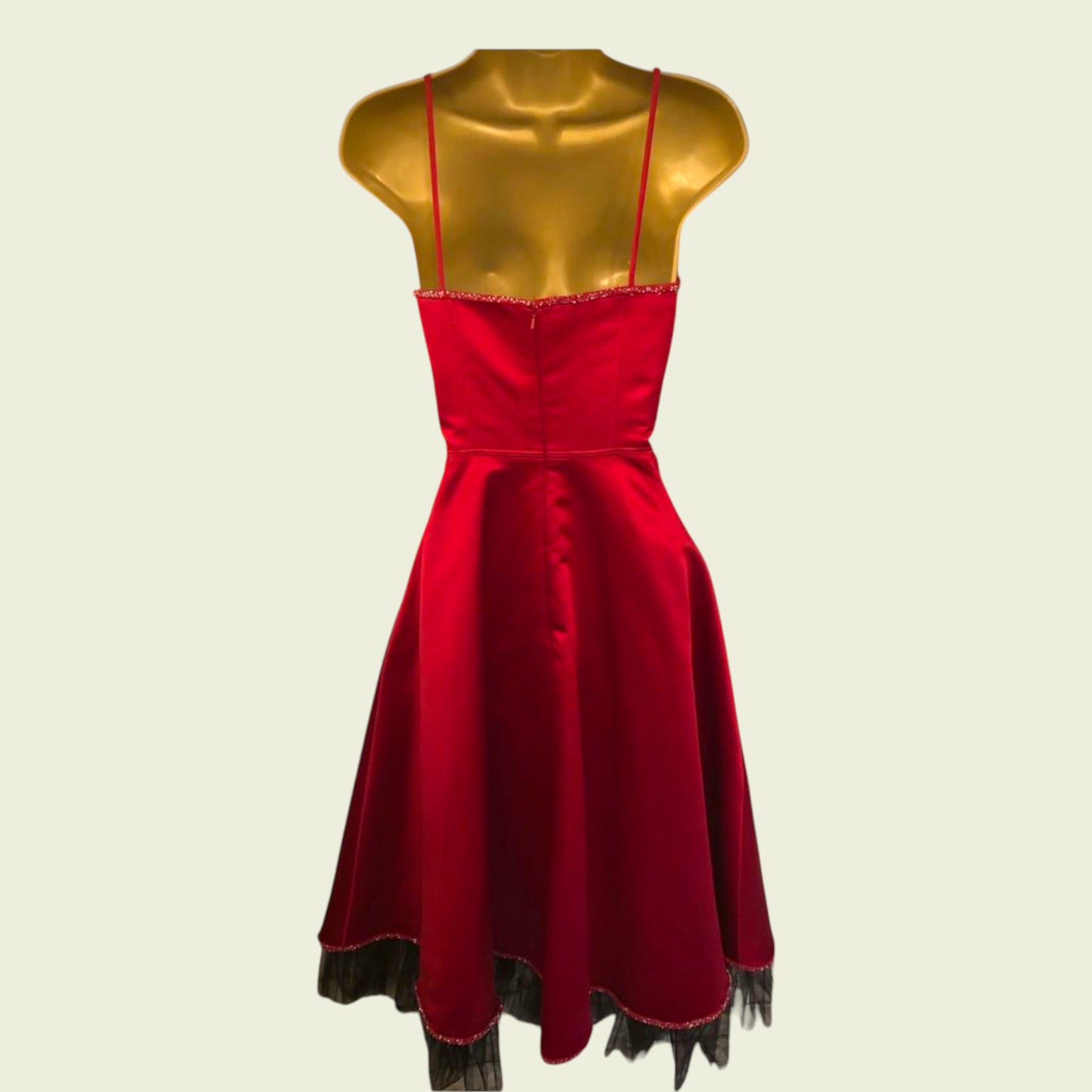 Back of red dress on mannequin on beige background