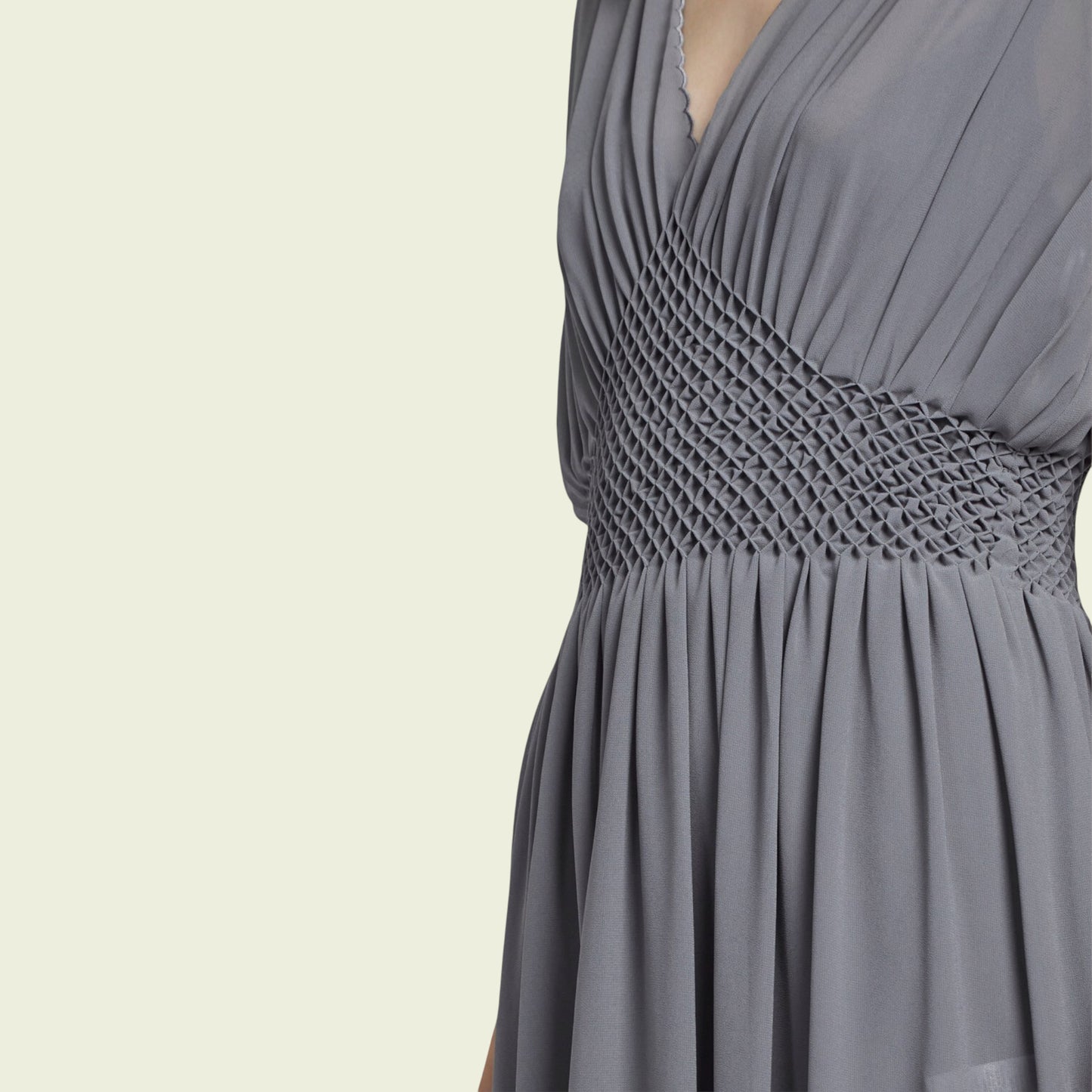 Gray dress with a textured waistband on a beige background
