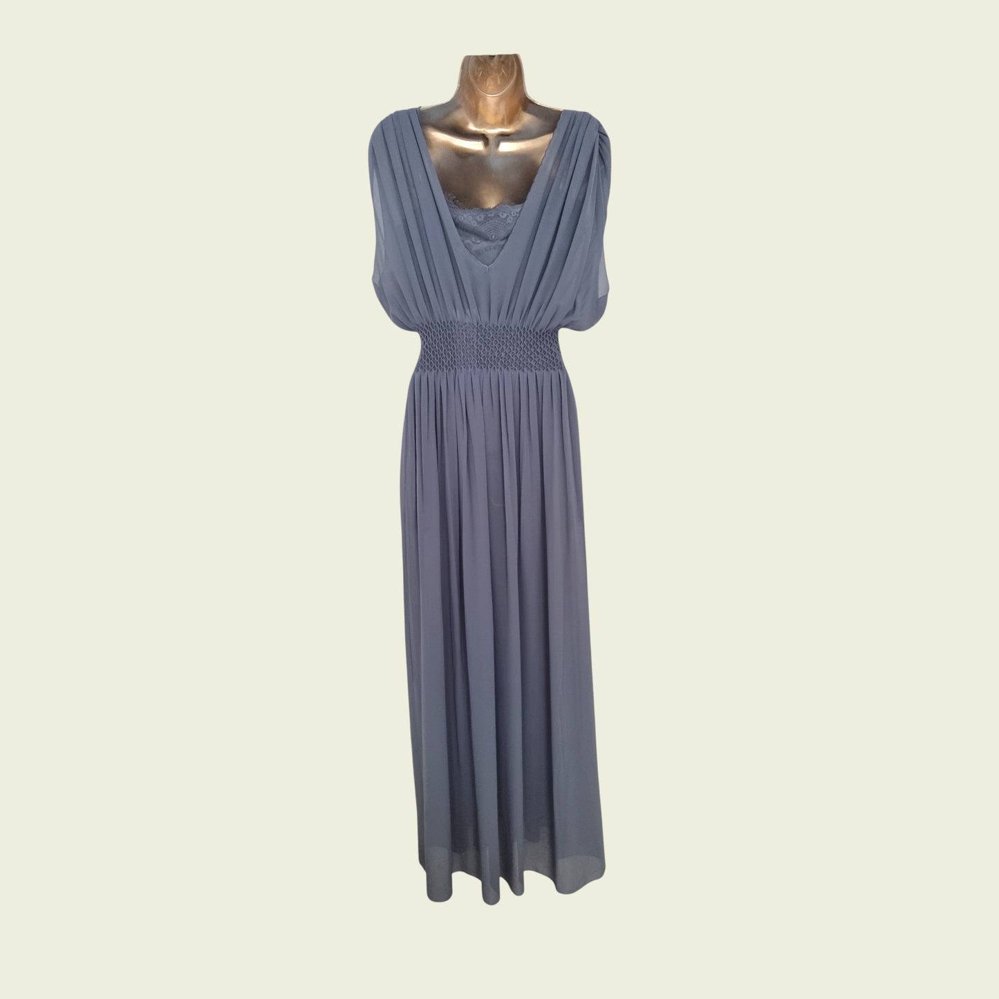Blue dress on a mannequin against a beige background