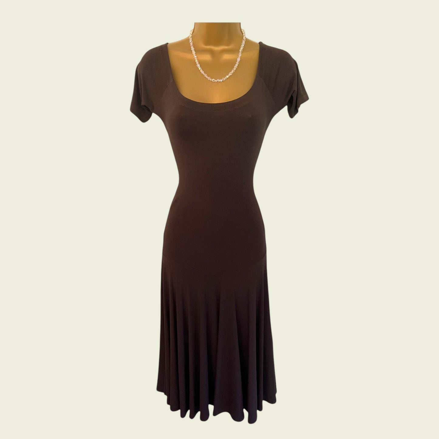 Brown dress on a mannequin with a plain background