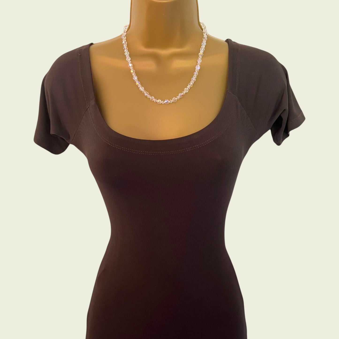 Front of brown dress on a mannequin with a plain background