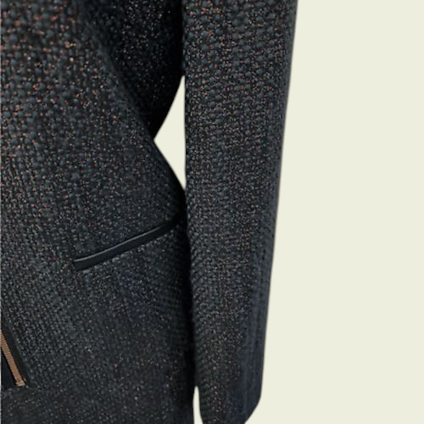 Close-up of a textured navy jacket on a light beige background