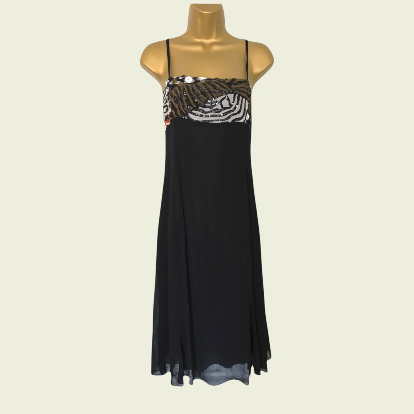 Black dress with zebra print top on a mannequin against a beige background