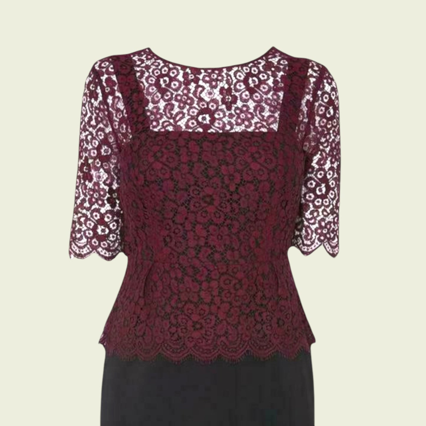 Red lace top with floral sleeves on a beige background