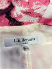 L.K. Bennett label on a garment with a floral pattern in the background