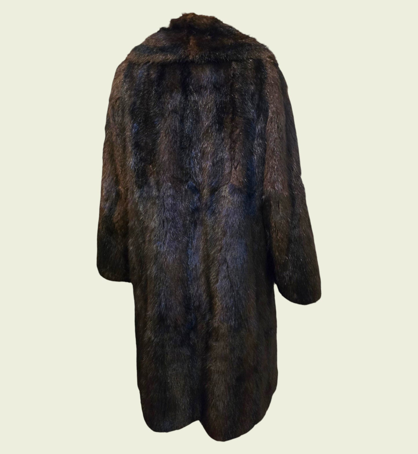 Dark brown fur coat on a light beige background