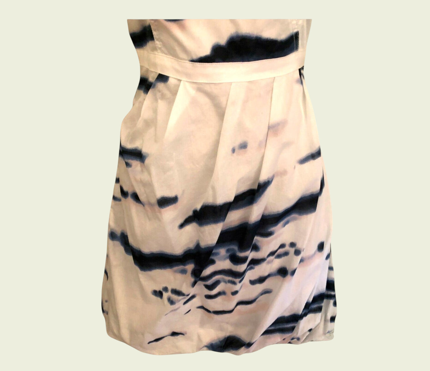 Beige dress with black tie-dye pattern on a beige background