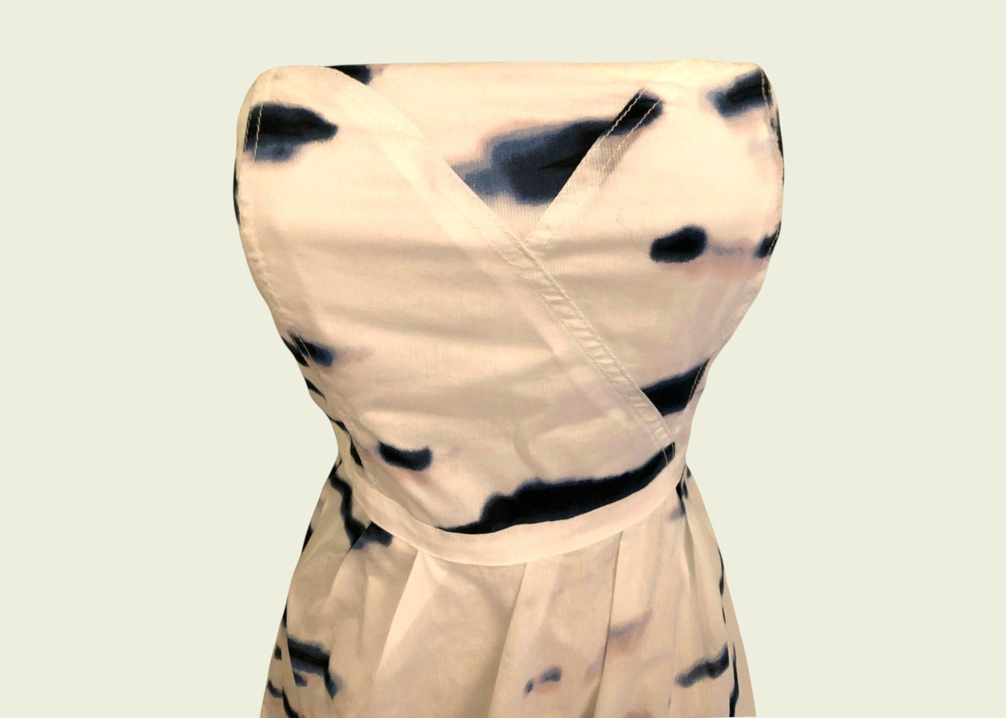 Beige dress with black abstract pattern on a light beige background