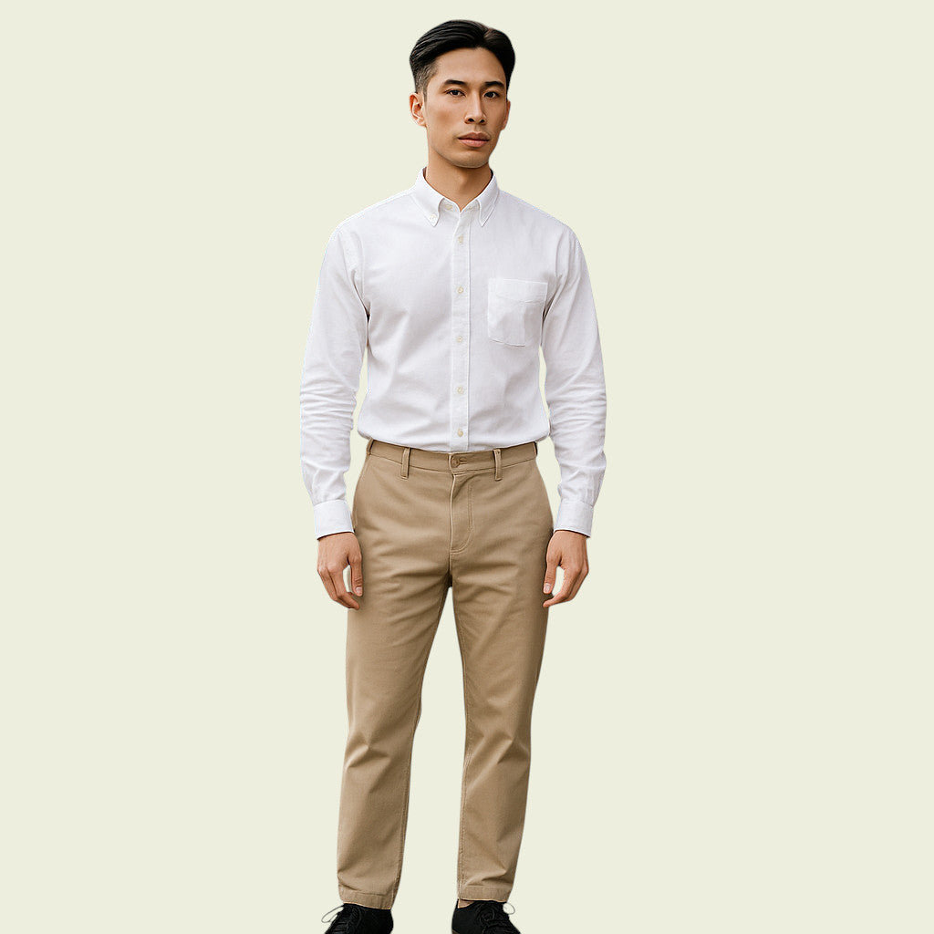 Man wearing a white dress shirt and beige pants on a light beige background