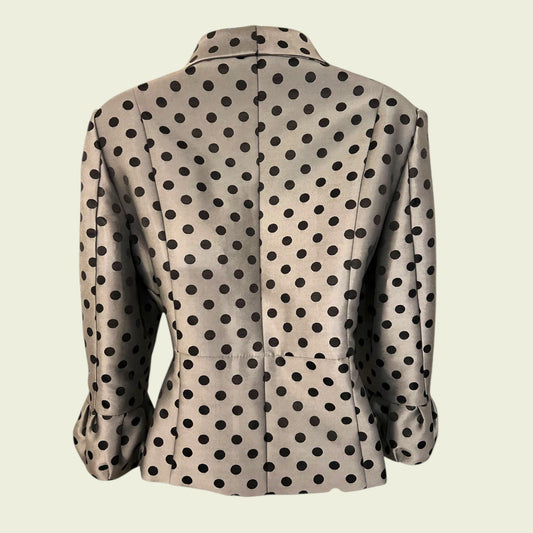 back of beige polka dot jacket on beige background