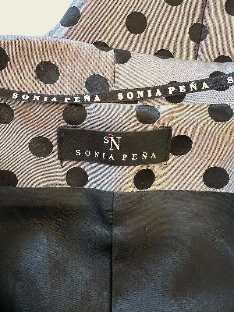 Sonia Pena label on grey polka dot background