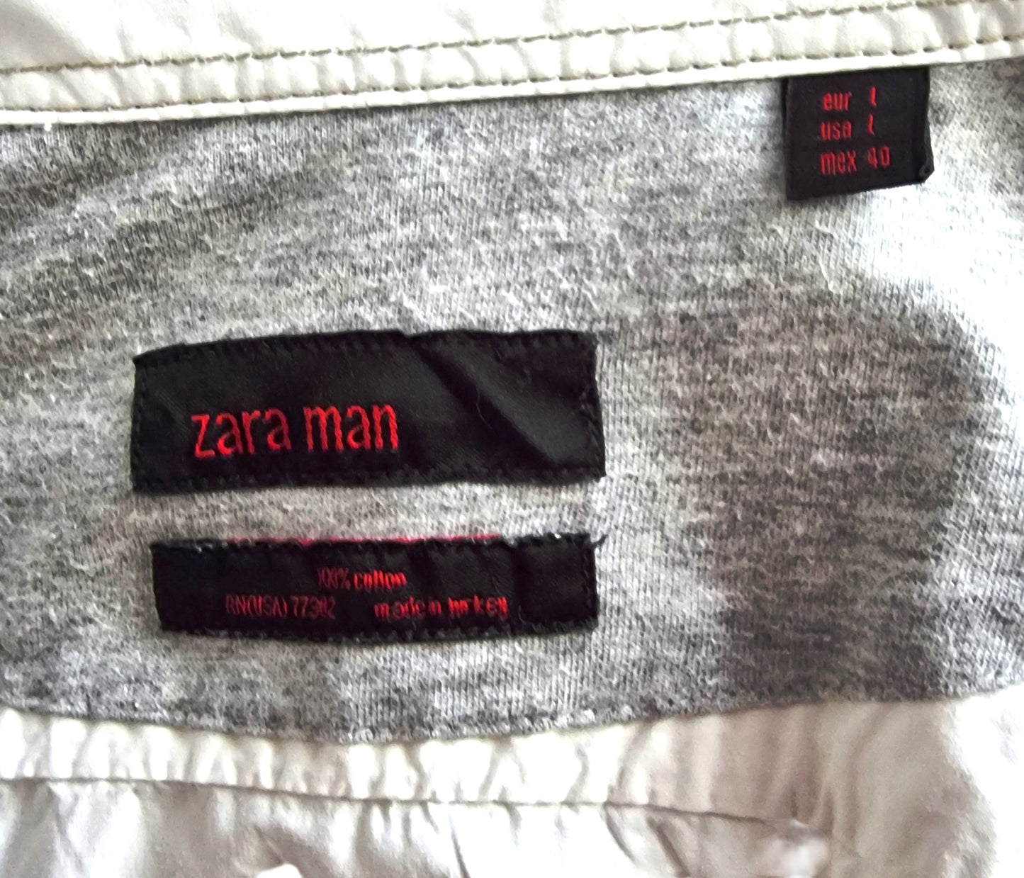Zara Man label on a piece of clothing with visible text.