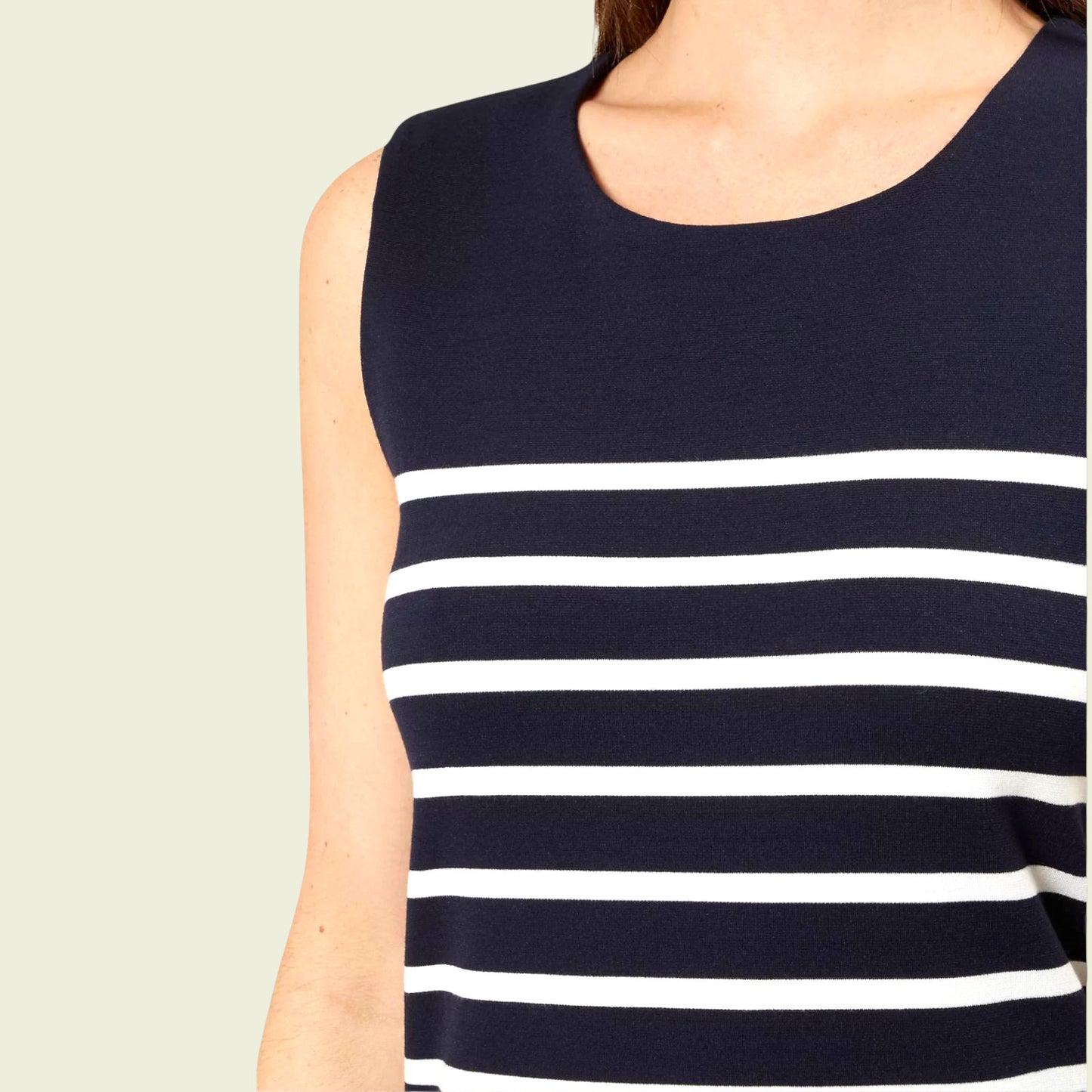 Navy and white striped sleeveless top on a neutral background