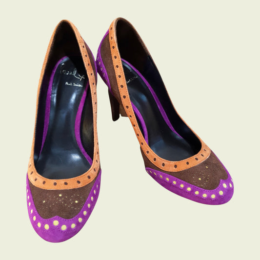 Purple high-heeled shoes with brown accents on a beige background
