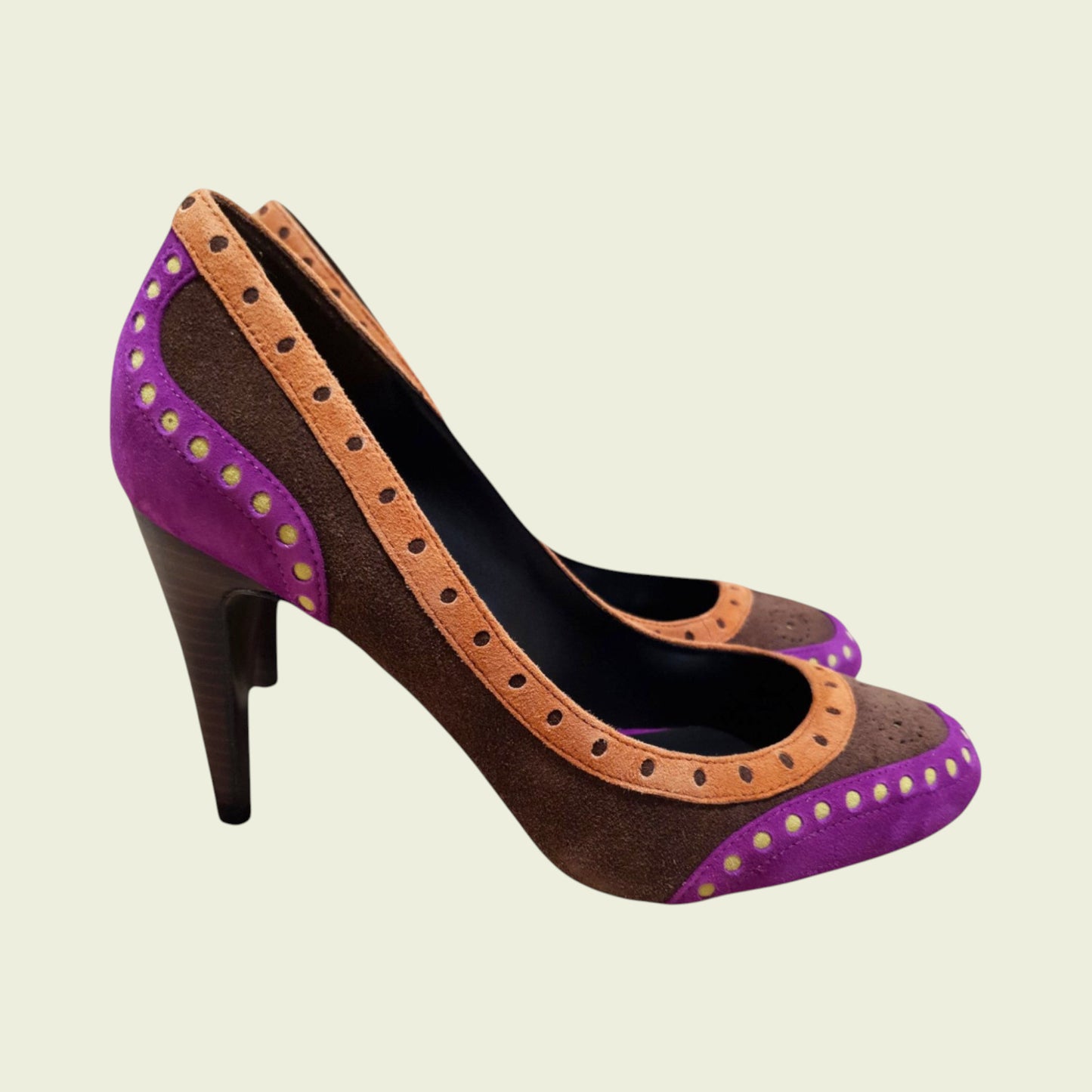 High-heeled shoe with purple and brown design on a beige background