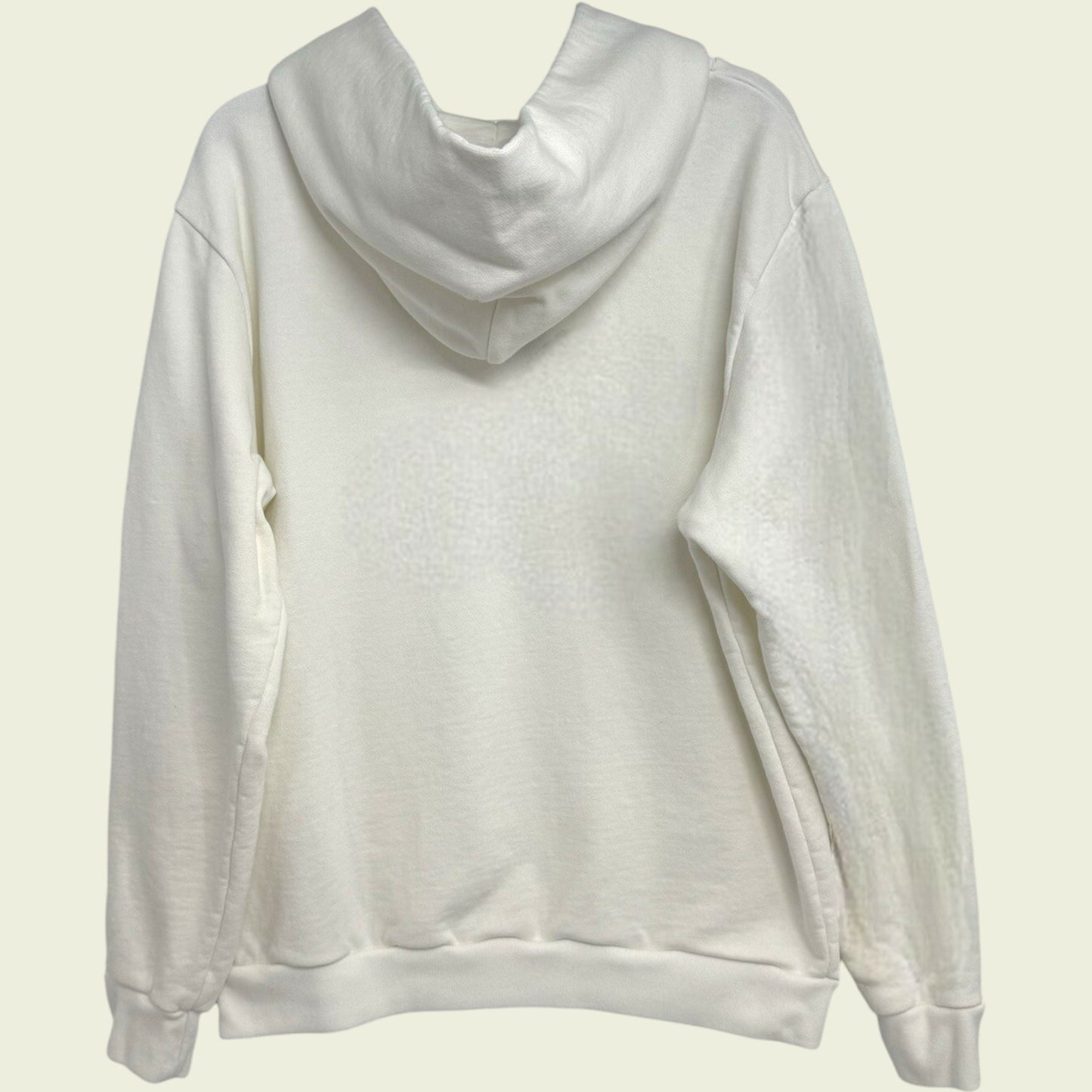 White hoodie on a light beige background