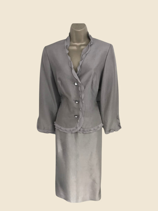 Gray skirt suit on a mannequin against a beige background