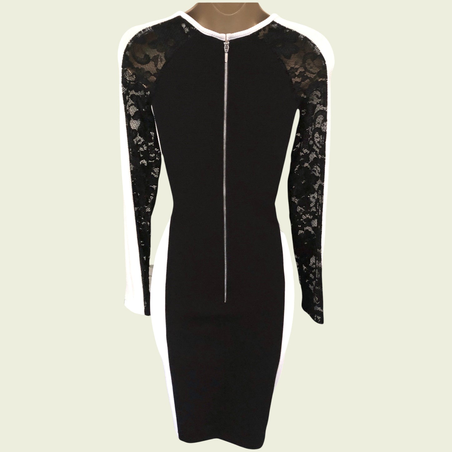 Black dress with lace sleeves on a beige background