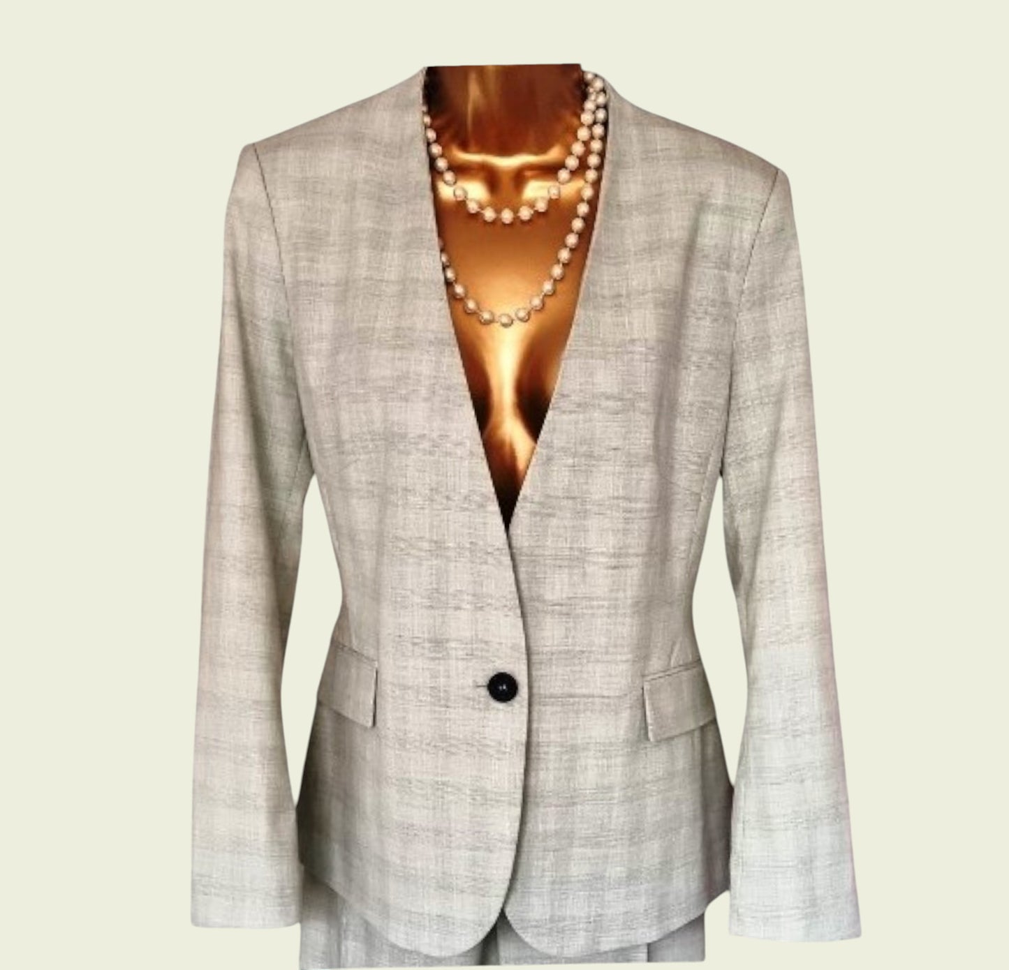 Mint green blazer with a pearl necklace on a beige background