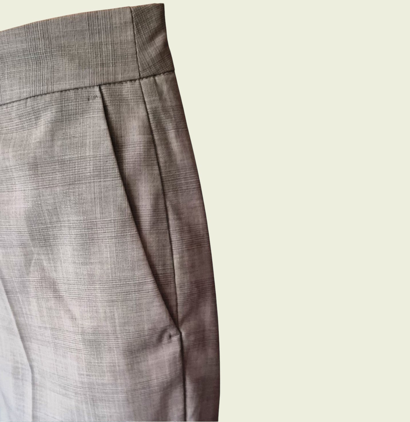 Close-up of trouser pocket on a beige background