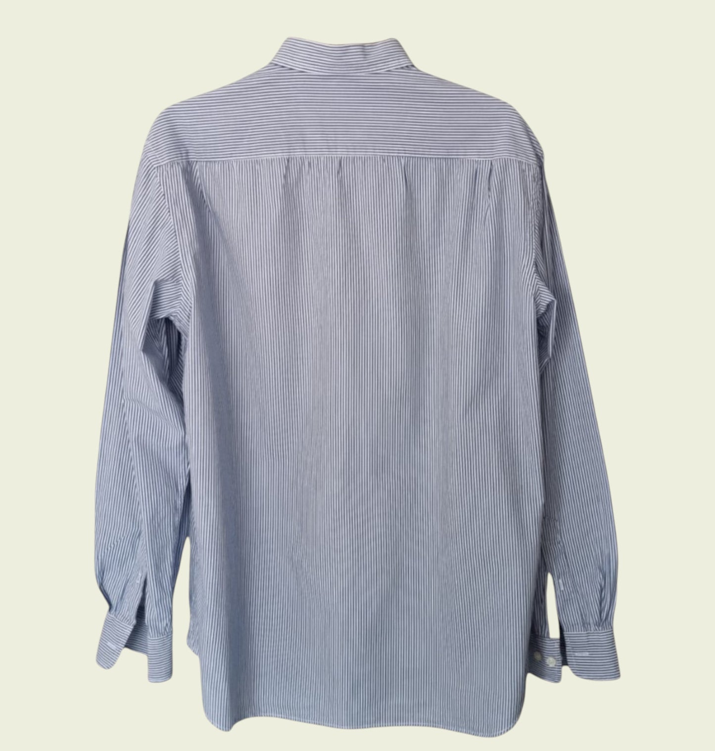 Blue and white striped shirt on a beige background