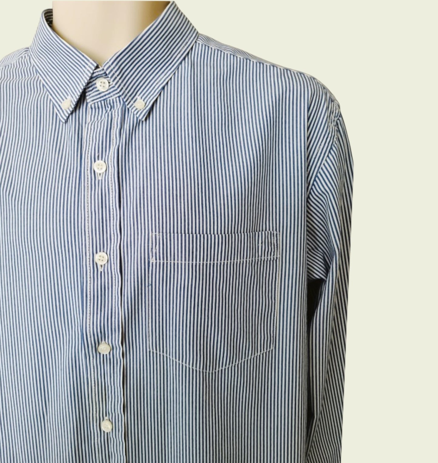 Blue and white striped shirt on a mannequin against a beige background