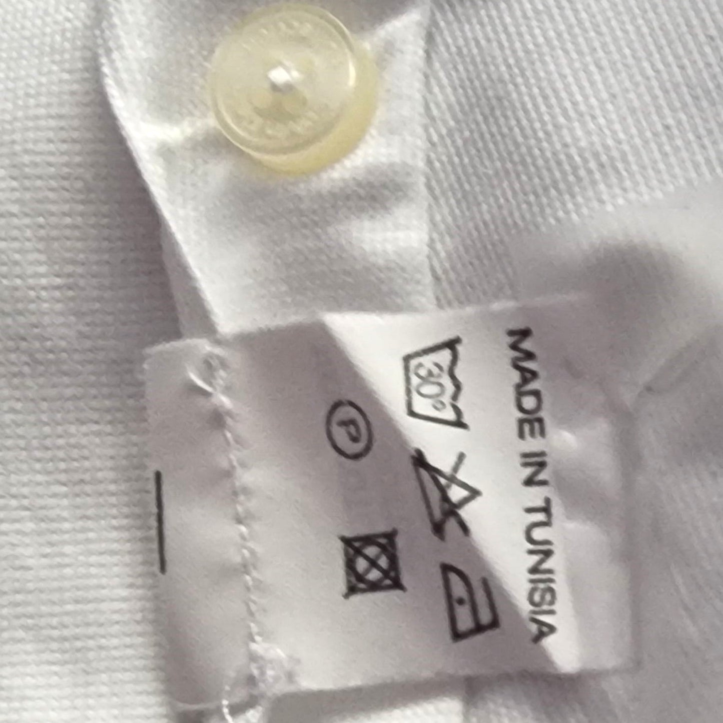 Close-up of a clothing label on a white fabric background
