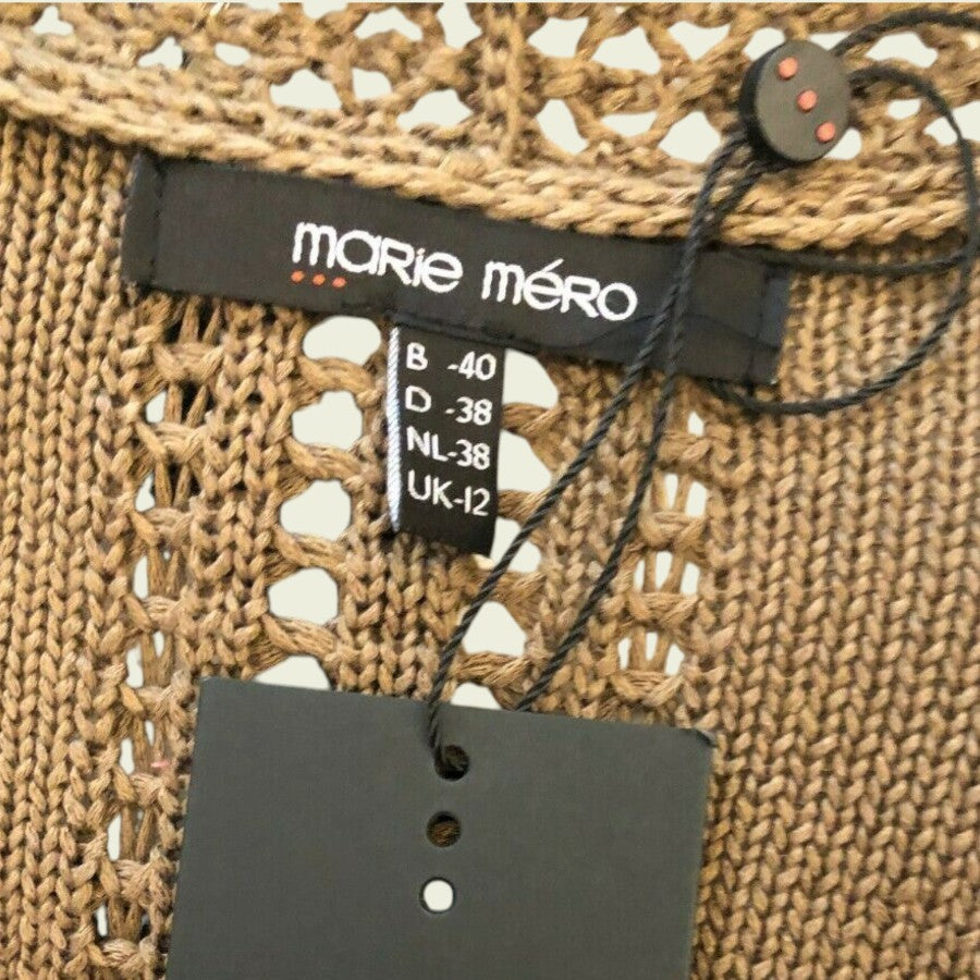 Close-up of a woven fabric with a 'Marie Méro' label and a tag.