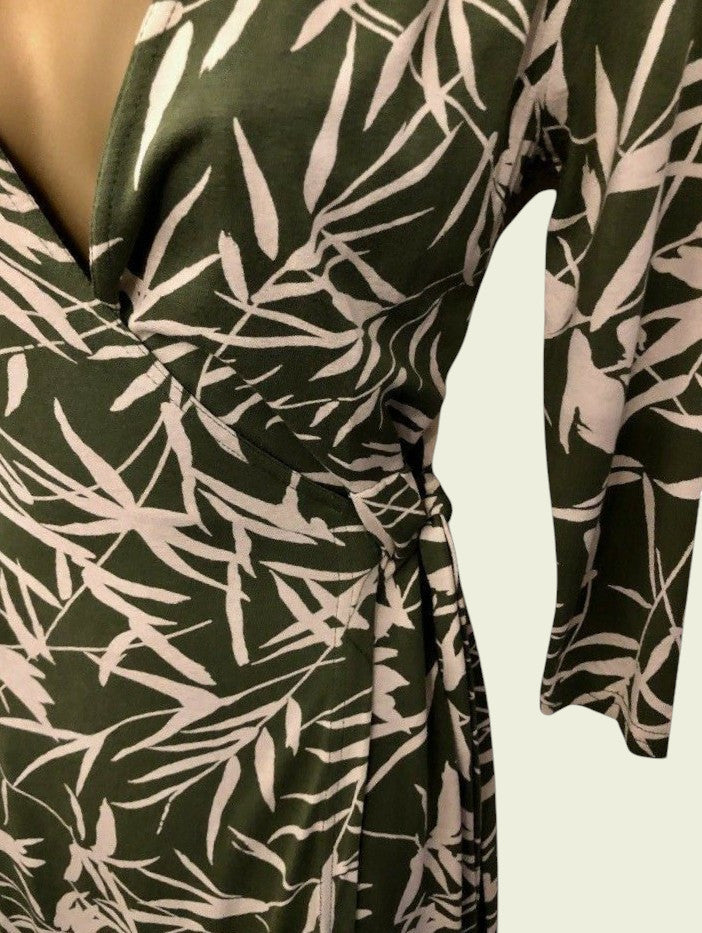 Green dress with white leaf pattern on a white background