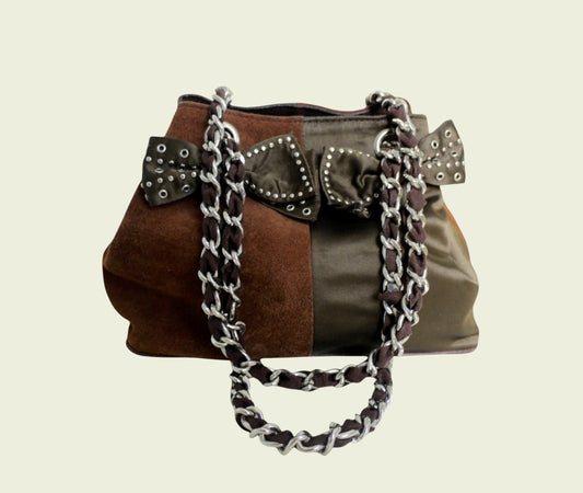 Brown patchwork handbag with chain detail on a beige background